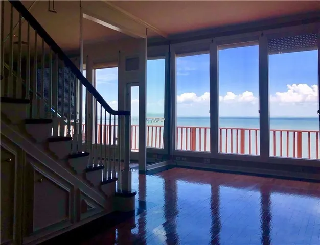a view of staircase with lots of wooden floor and windows