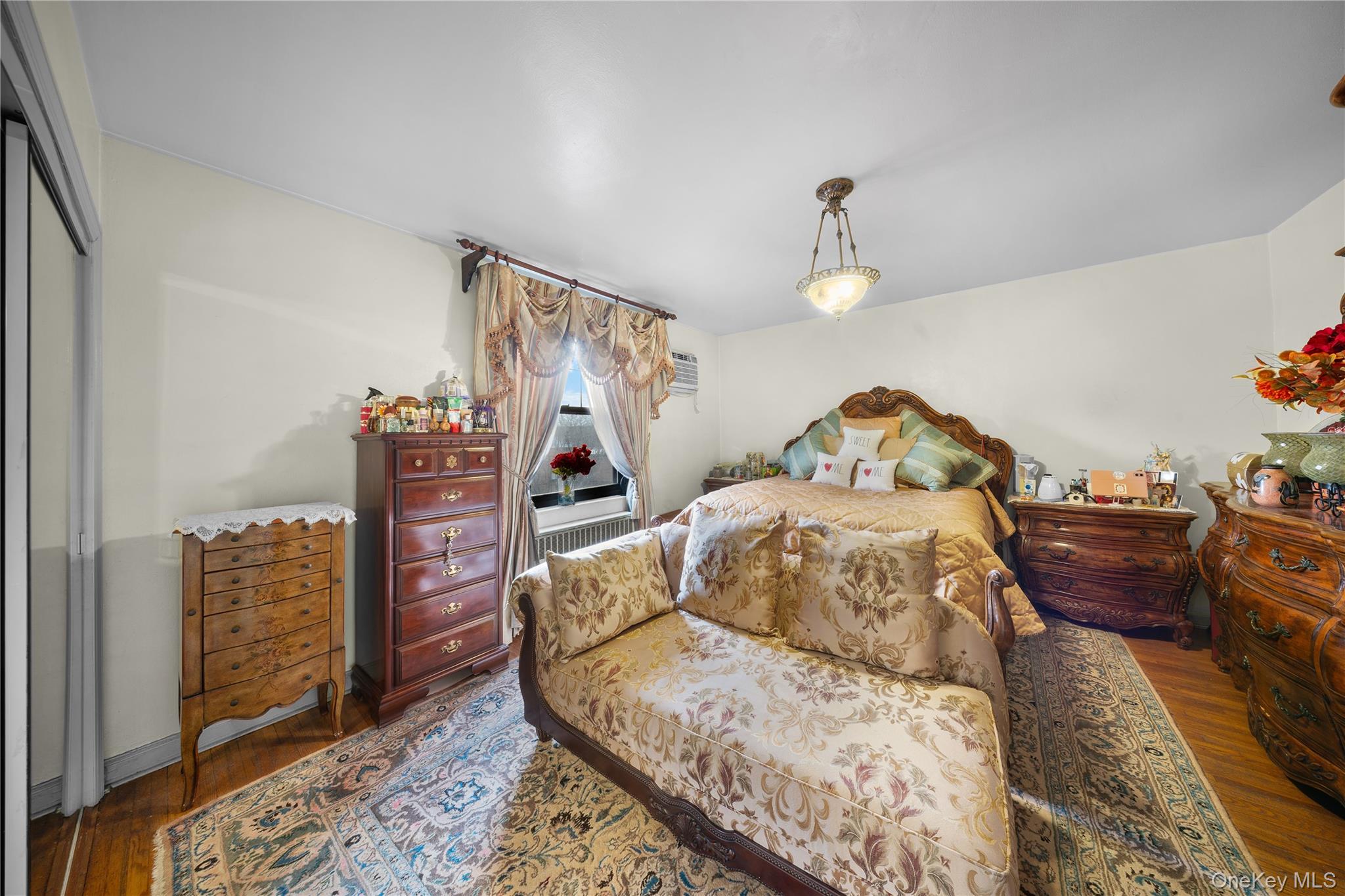 70-79 Park Drive East, Unit B Queens, NY 11367 - Photo 11 of 25 Bedroom featuring wood finished floors and radiator