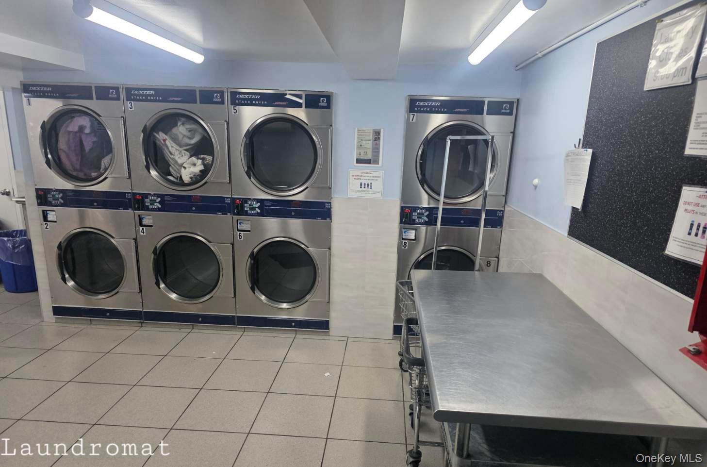 70-79 Park Drive East, Unit B Queens, NY 11367 - Photo 16 of 25 Shared laundry with stacked washer and clothes dryer and tile walls
