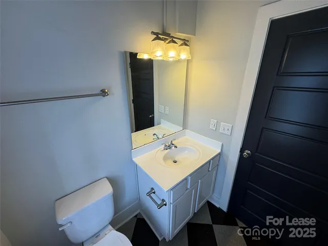 a bathroom with a sink a toilet and mirror
