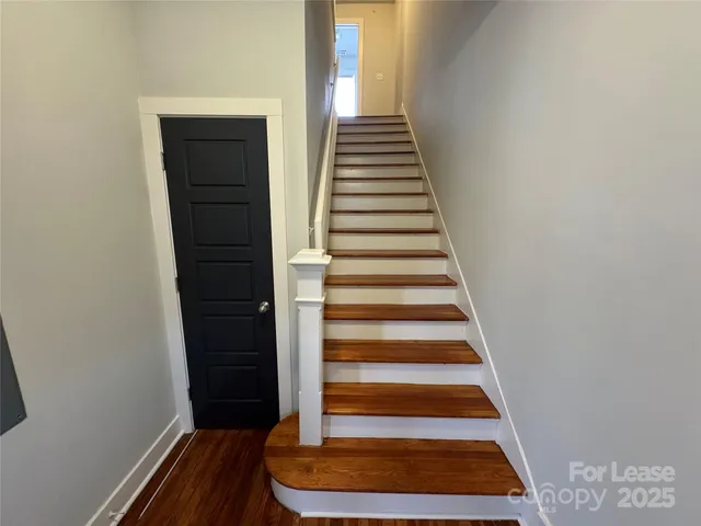 a view of entryway with wooden floor and door