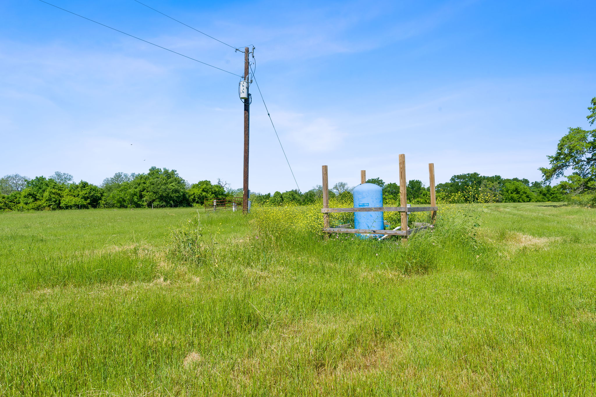 663 Sh 230 Loop Smithville, TX 78957 - Photo 14 of 36 a view of a lake with a big yard and potted plants