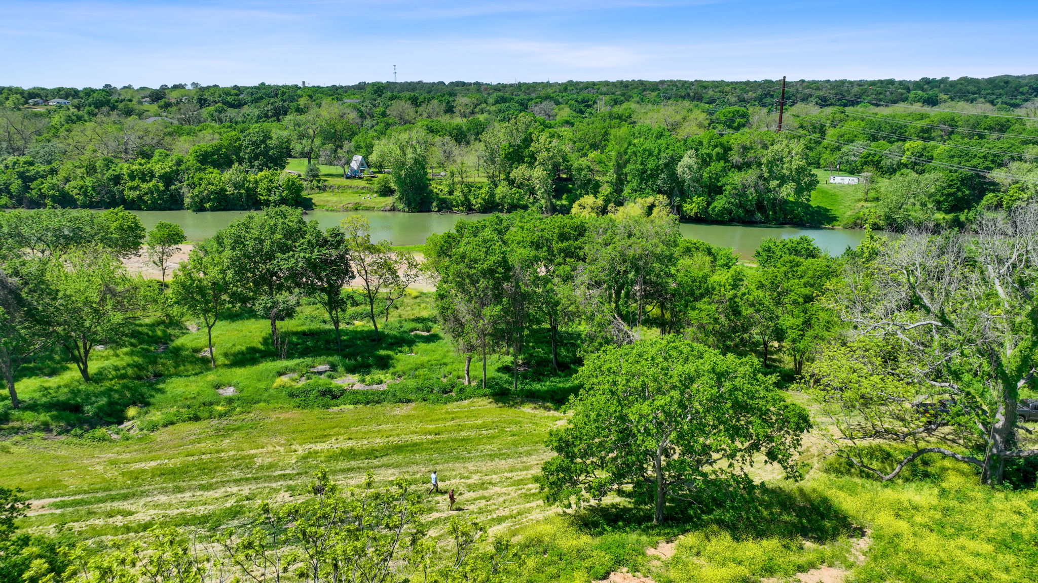 663 Sh 230 Loop Smithville, TX 78957 - Photo 15 of 36 a view of a lush green outdoor space with a lake view