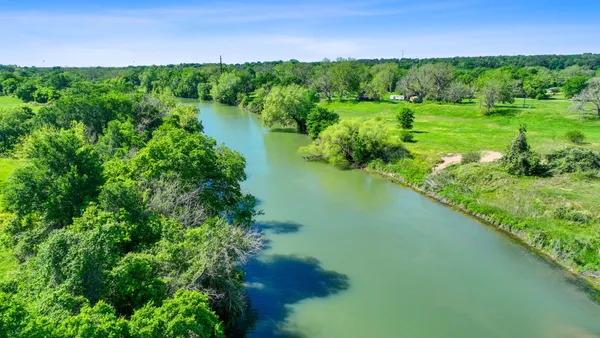 a view of a lake with a yard