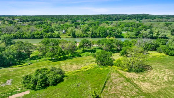 a view of a lush green outdoor space with a lake view