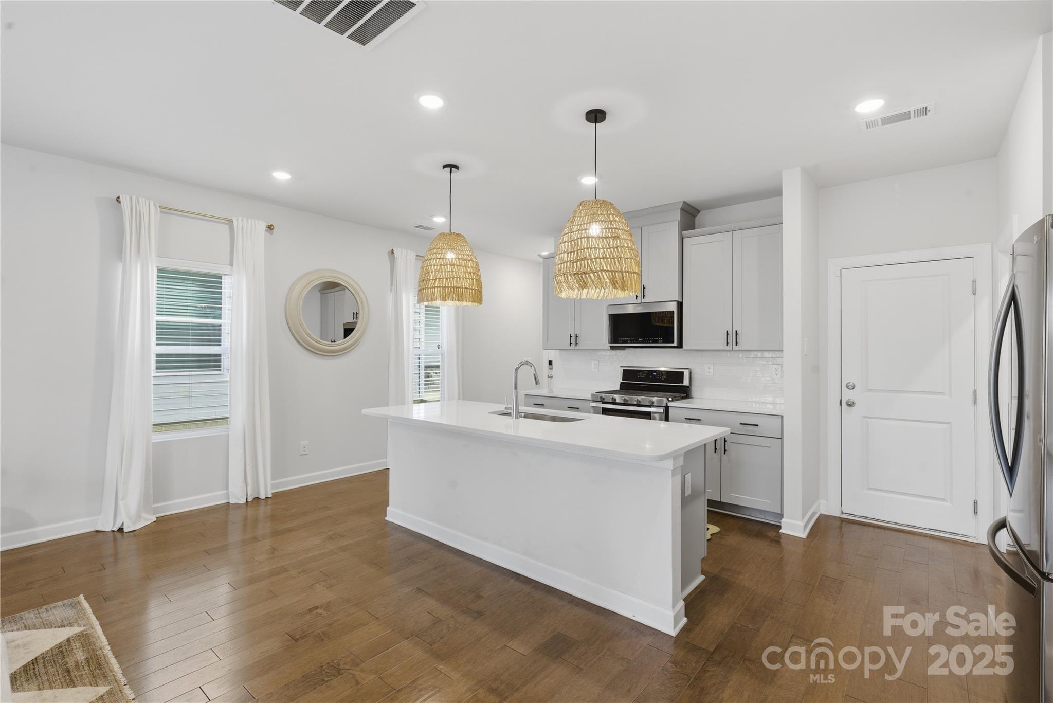3528 Auburn Curb Road Charlotte, NC 28217 - Photo 6 of 35 a view of a kitchen with kitchen island a sink stainless steel appliances and cabinets