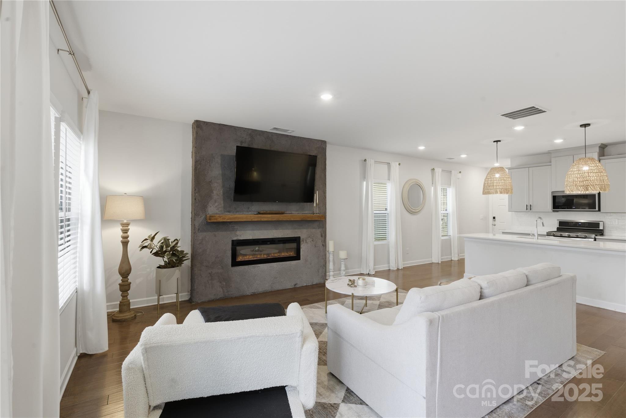 3528 Auburn Curb Road Charlotte, NC 28217 - Photo 10 of 35 a living room with furniture and a flat screen tv