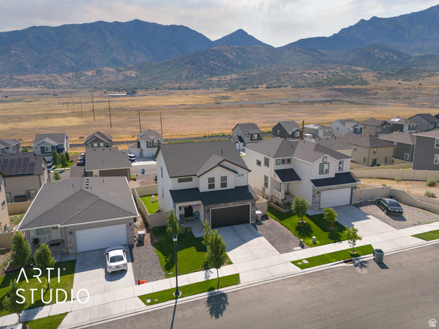 1713 South Windemere Road Santaquin, UT 84655 - Photo 37 of 40 Modern two-story residence featuring a two-car garage, stone and siding exterior, and landscaped front yard