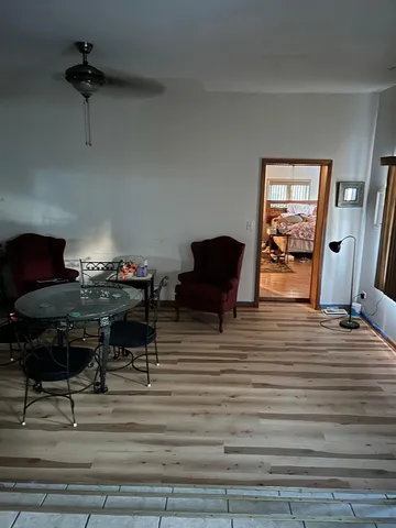 a living room with furniture and a piano