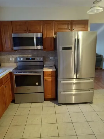 a kitchen with granite countertop a stove and a microwave