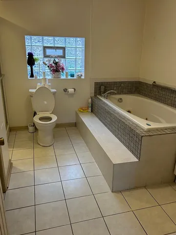 a bathroom with a bathtub and toilet