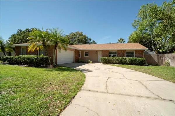 a front view of house with yard and green space