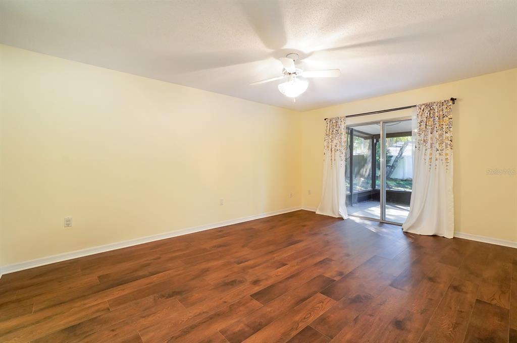 6260 Morning Mist Lane Orlando, FL 32819 - Photo 12 of 27 a view of an empty room with wooden floor and a window
