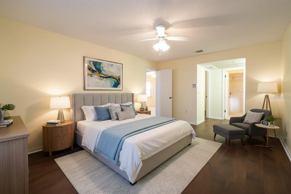 6260 Morning Mist Lane Orlando, FL 32819 - Photo 13 of 27 a bedroom with a bed and a chandelier