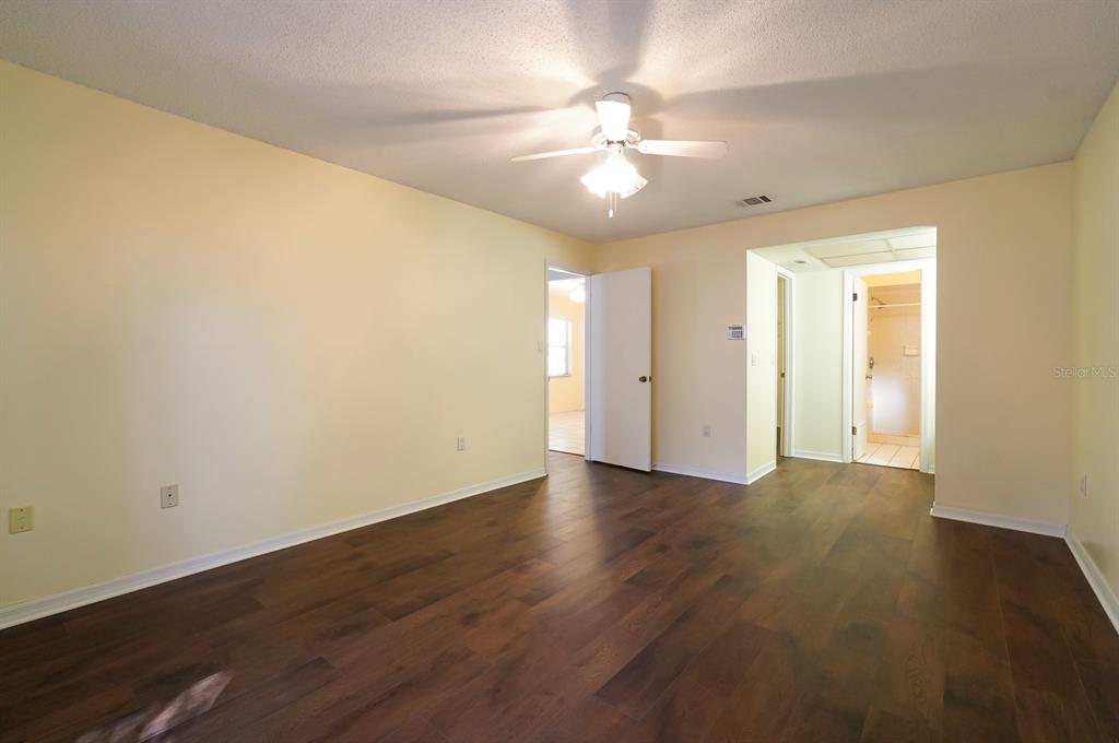 6260 Morning Mist Lane Orlando, FL 32819 - Photo 14 of 27 a view of an empty room with wooden floor