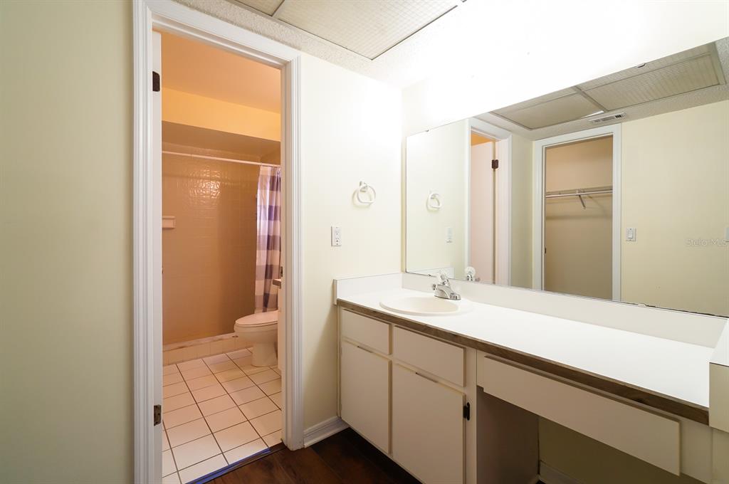 6260 Morning Mist Lane Orlando, FL 32819 - Photo 15 of 27 a bathroom with a sink a toilet and shower