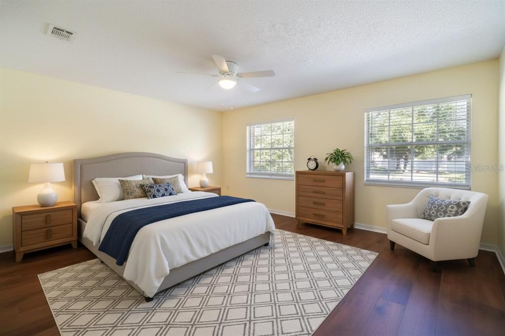 6260 Morning Mist Lane Orlando, FL 32819 - Photo 17 of 27 a bedroom with a bed a couch and a window