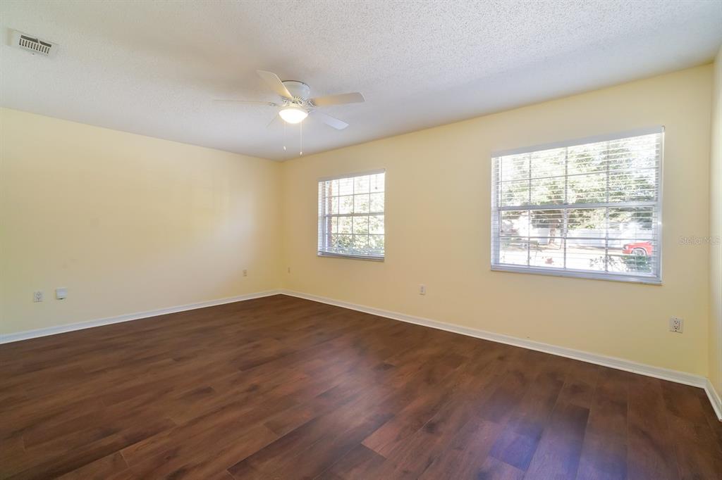 6260 Morning Mist Lane Orlando, FL 32819 - Photo 18 of 27 a view of an empty room with wooden floor and a window
