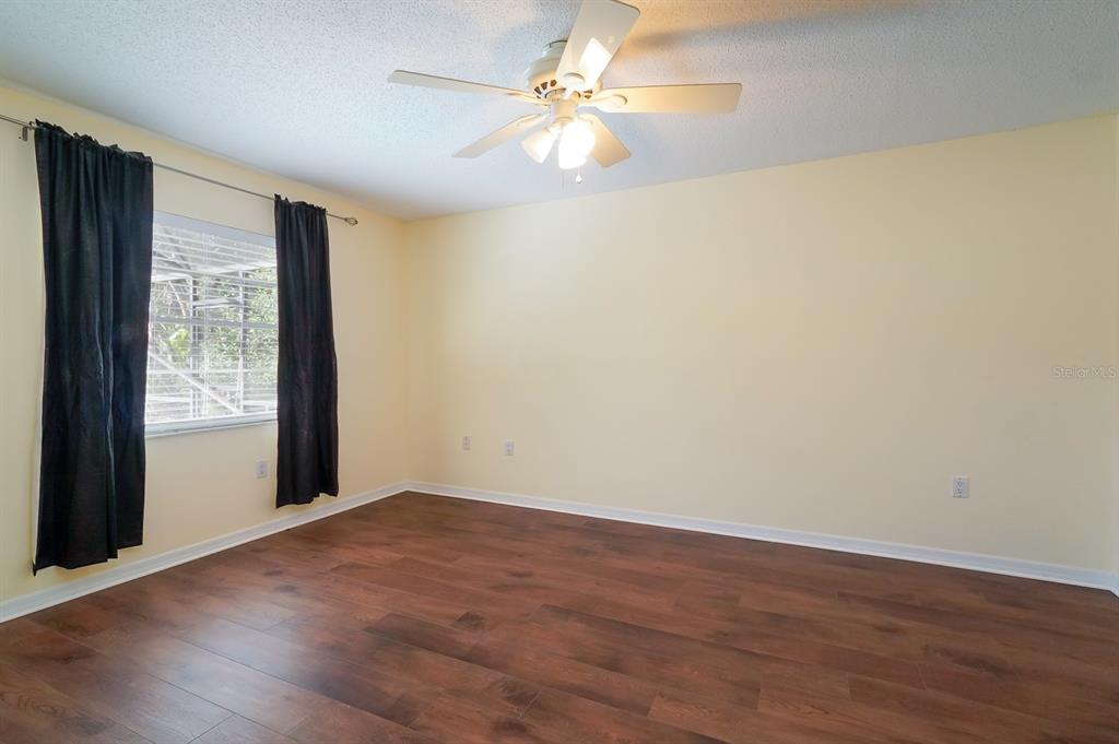 6260 Morning Mist Lane Orlando, FL 32819 - Photo 22 of 27 a view of an empty room with window and wooden floor