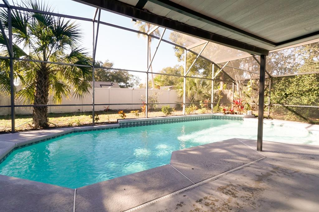 6260 Morning Mist Lane Orlando, FL 32819 - Photo 24 of 27 a view of a swimming pool with a yard