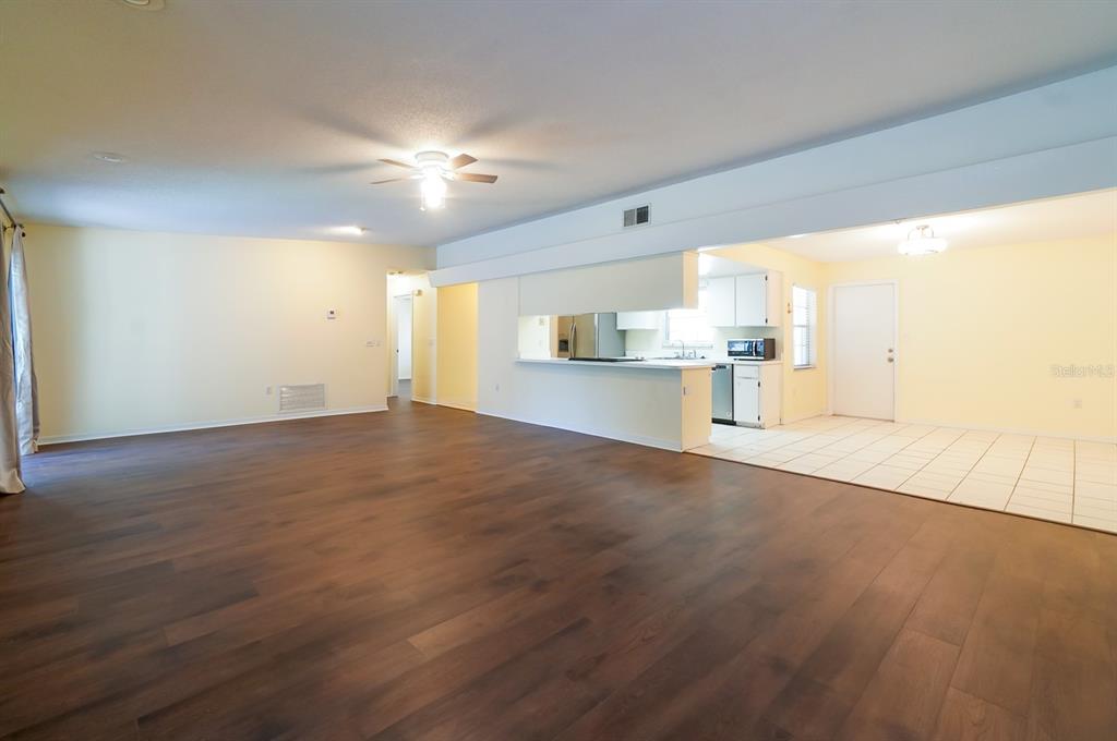 6260 Morning Mist Lane Orlando, FL 32819 - Photo 8 of 27 an empty room with wooden floor and windows