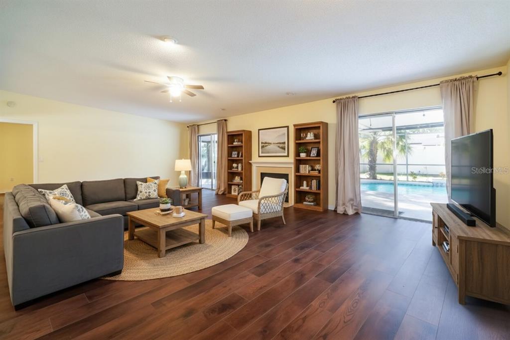 6260 Morning Mist Lane Orlando, FL 32819 - Photo 10 of 27 a living room with furniture and a flat screen tv