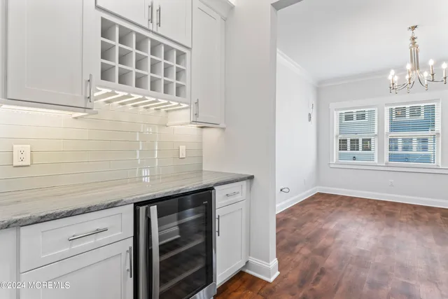 a view of kitchen with granite countertop cabinets and window