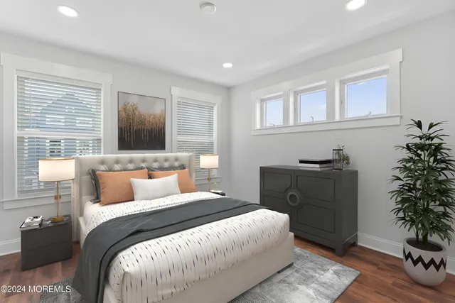 a bedroom with a large bed and a potted plant