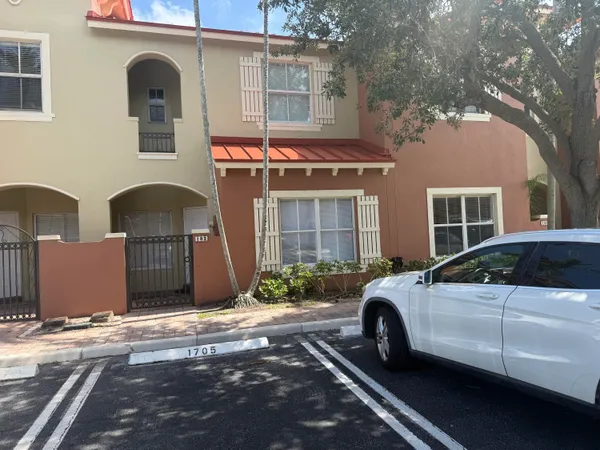 a front view of a house with parking space