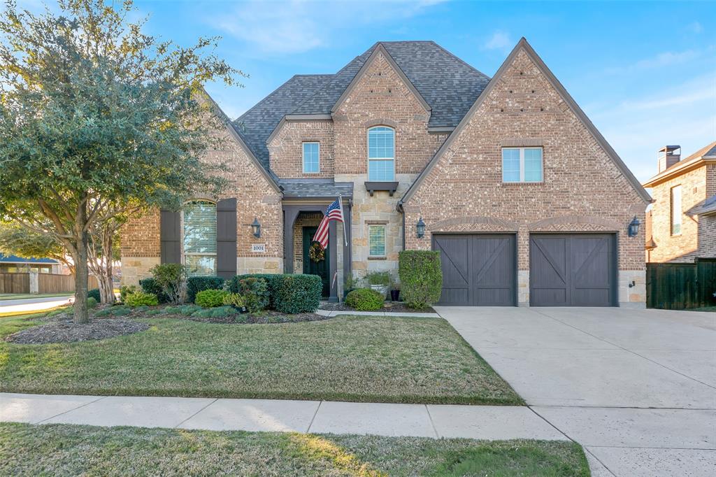 1001 West Bluff Way Roanoke, TX 76262 - Photo 2 of 40 View of front of house with brick siding, concrete driveway, an attached garage, and roof with shingles