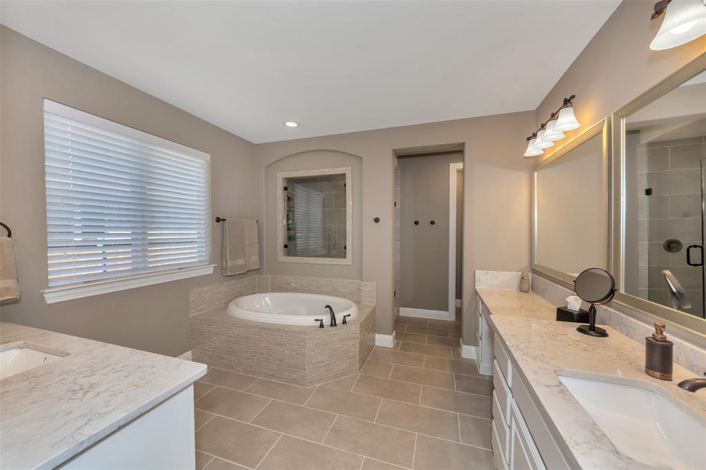 1001 West Bluff Way Roanoke, TX 76262 - Photo 21 of 40 Bathroom featuring two vanities, a garden tub, light tile patterned floors, and a stall shower
