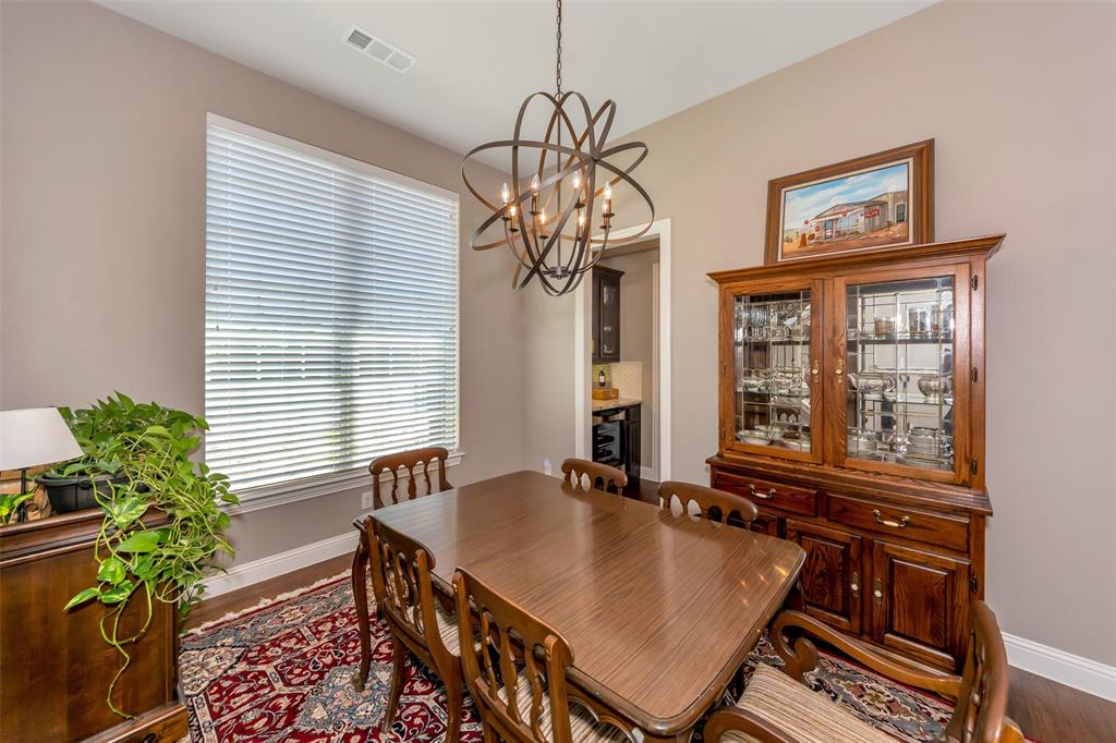 1001 West Bluff Way Roanoke, TX 76262 - Photo 24 of 40 Dining room featuring wood finished floors and a chandelier