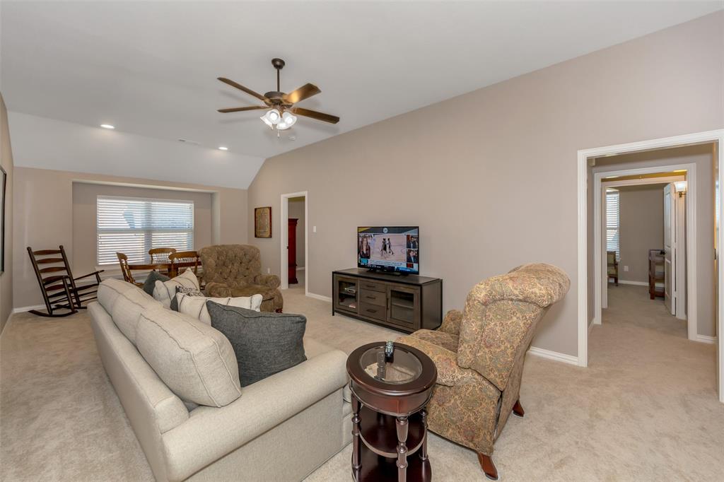 1001 West Bluff Way Roanoke, TX 76262 - Photo 25 of 40 Living area with light colored carpet, ceiling fan, lofted ceiling, and recessed lighting