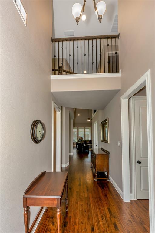 1001 West Bluff Way Roanoke, TX 76262 - Photo 4 of 40 Foyer entrance with dark wood-style flooring, a high ceiling, and a chandelier