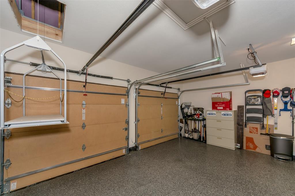 1001 West Bluff Way Roanoke, TX 76262 - Photo 9 of 40 Garage featuring a garage door opener, and a versa lift to make attic storage a breeze.