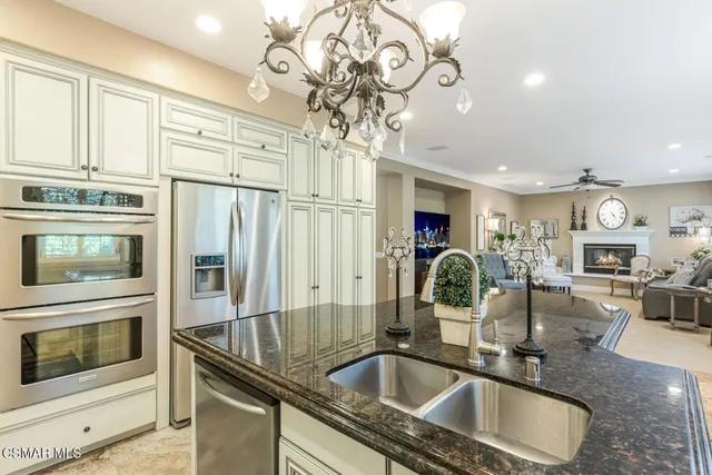 a kitchen with stainless steel appliances granite countertop a sink and cabinets