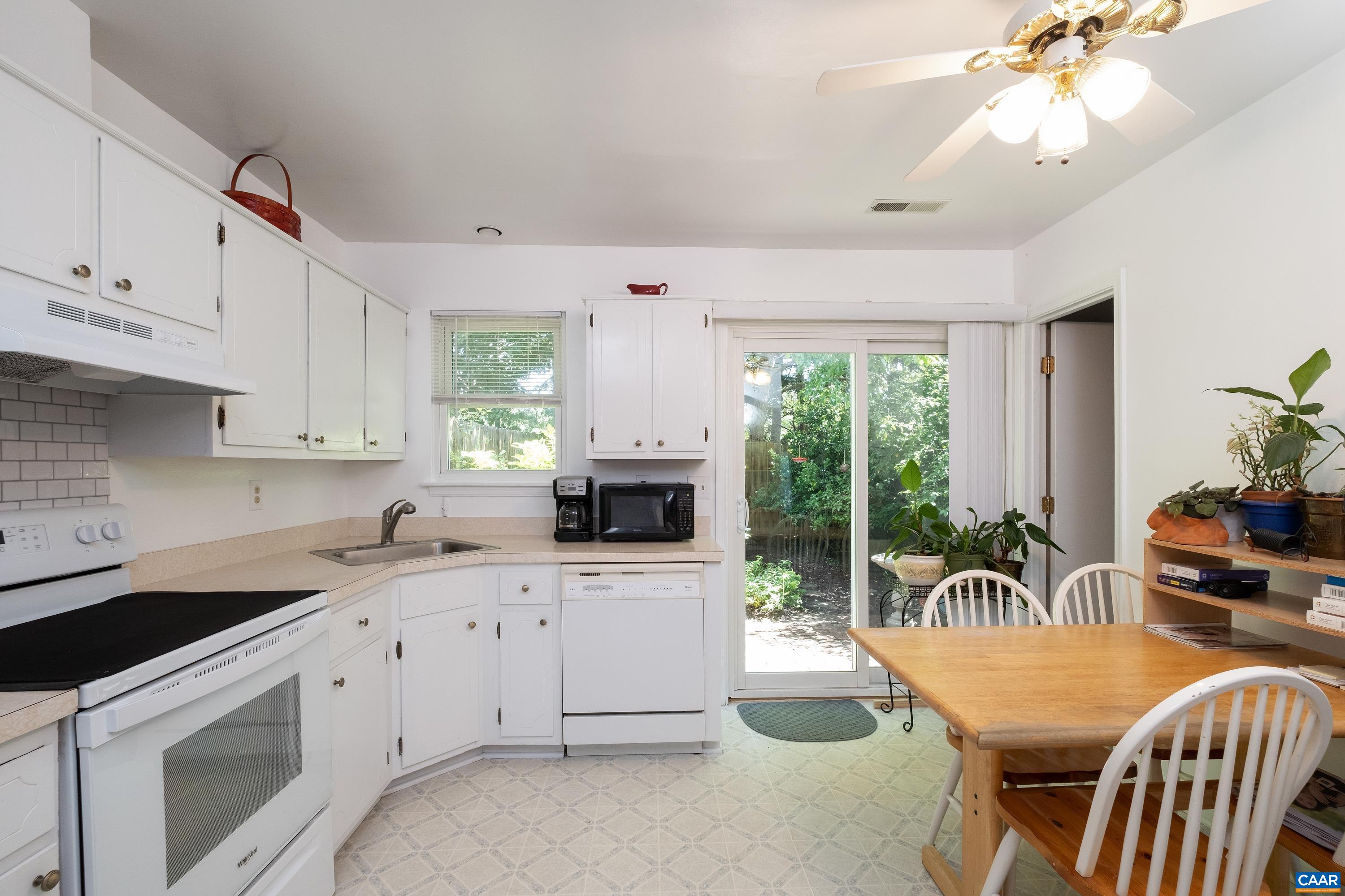 1596 Cool Spring Road Charlottesville, VA 22901 - Photo 8 of 24 a kitchen with granite countertop a sink a stove a dining table and chairs