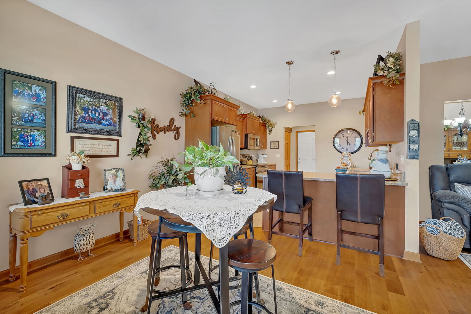 1761 Red Willow Road Morris, IL 60450 - Photo 13 of 38 a view of a dining room and livingroom with furniture wooden floor a rug a painting and a chandelier
