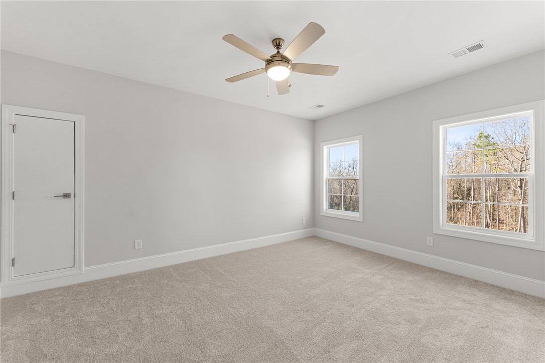 141 Rickys Path Easley, SC 29642 - Photo 27 of 40 This bright bedroom offers tranquil tree views and a welcoming, expansive atmosphere.