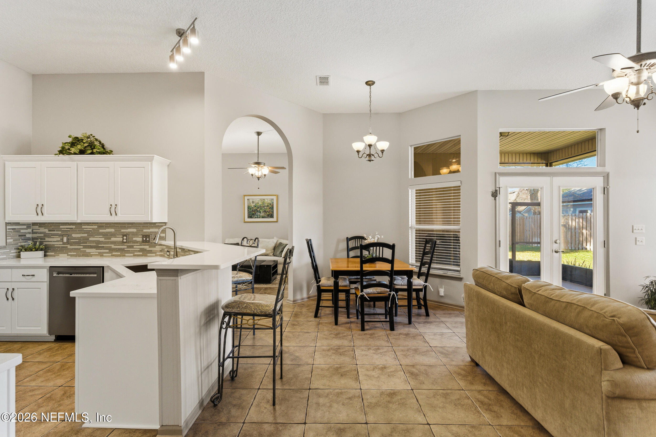 4309 Rye Court St. Johns, FL 32259 - Photo 14 of 55 a living room with couches a dining table and chairs with a stove top oven