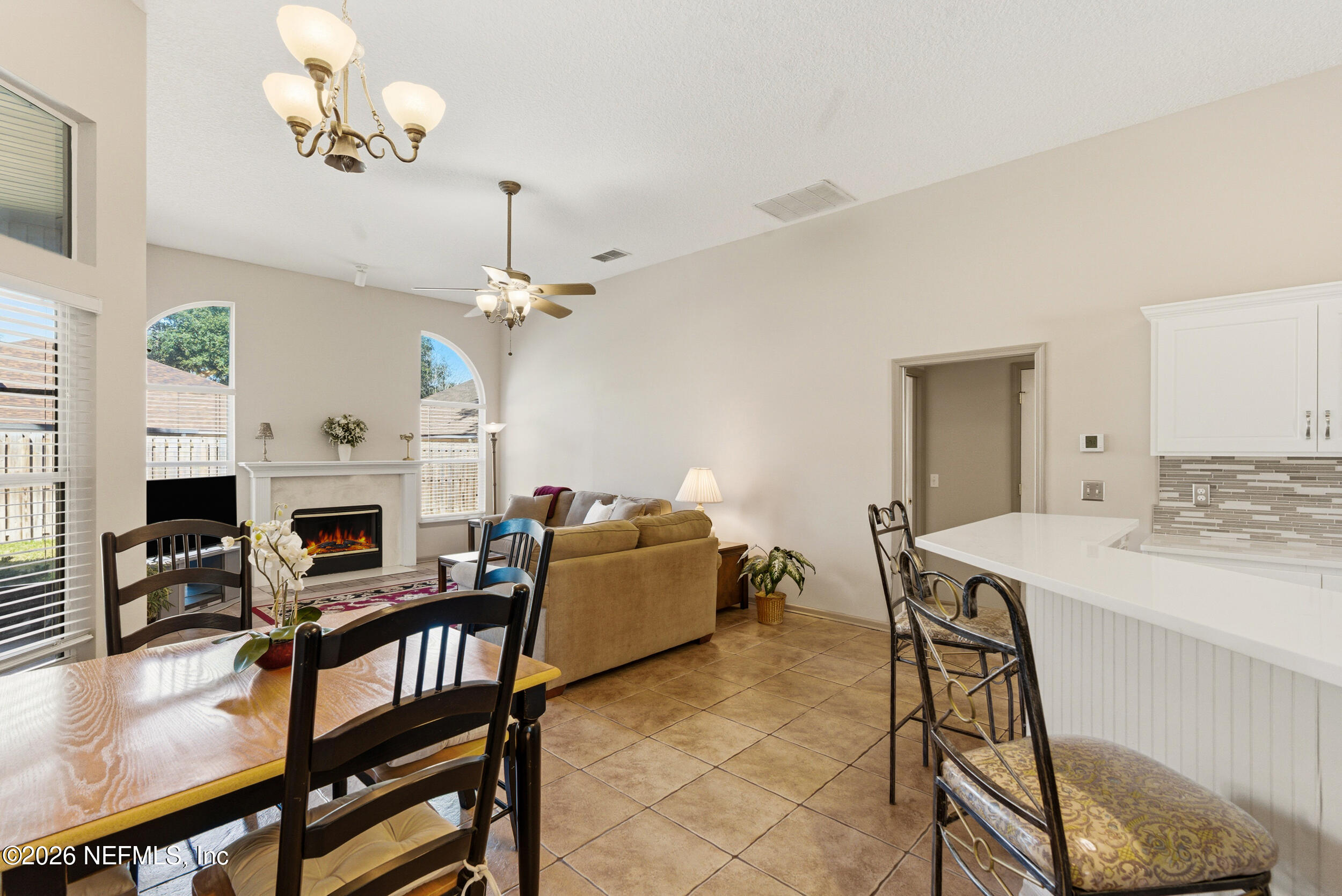 4309 Rye Court St. Johns, FL 32259 - Photo 15 of 55 a view of a dining room with furniture and a fireplace