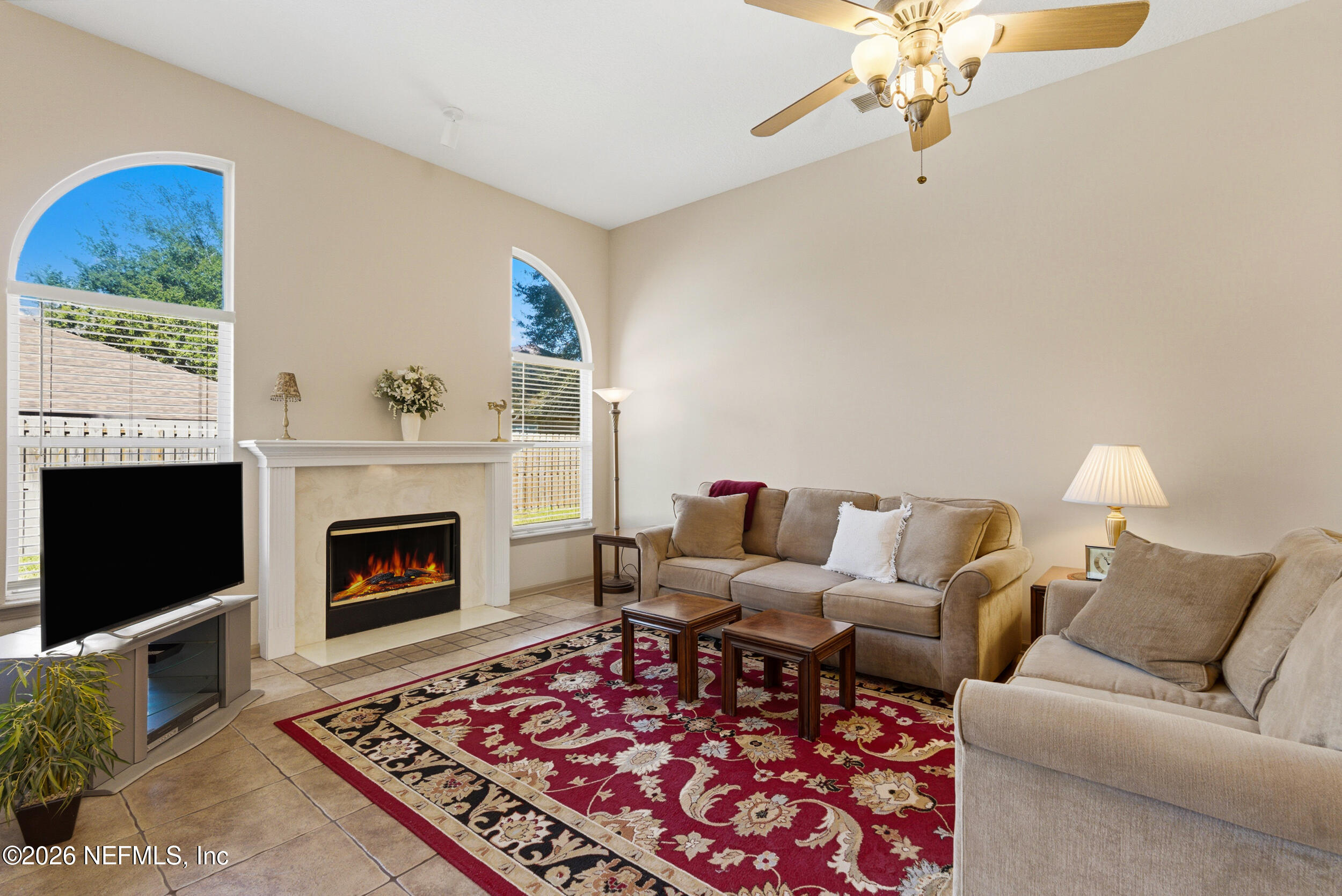 4309 Rye Court St. Johns, FL 32259 - Photo 16 of 55 a living room with furniture a flat screen tv and a fireplace