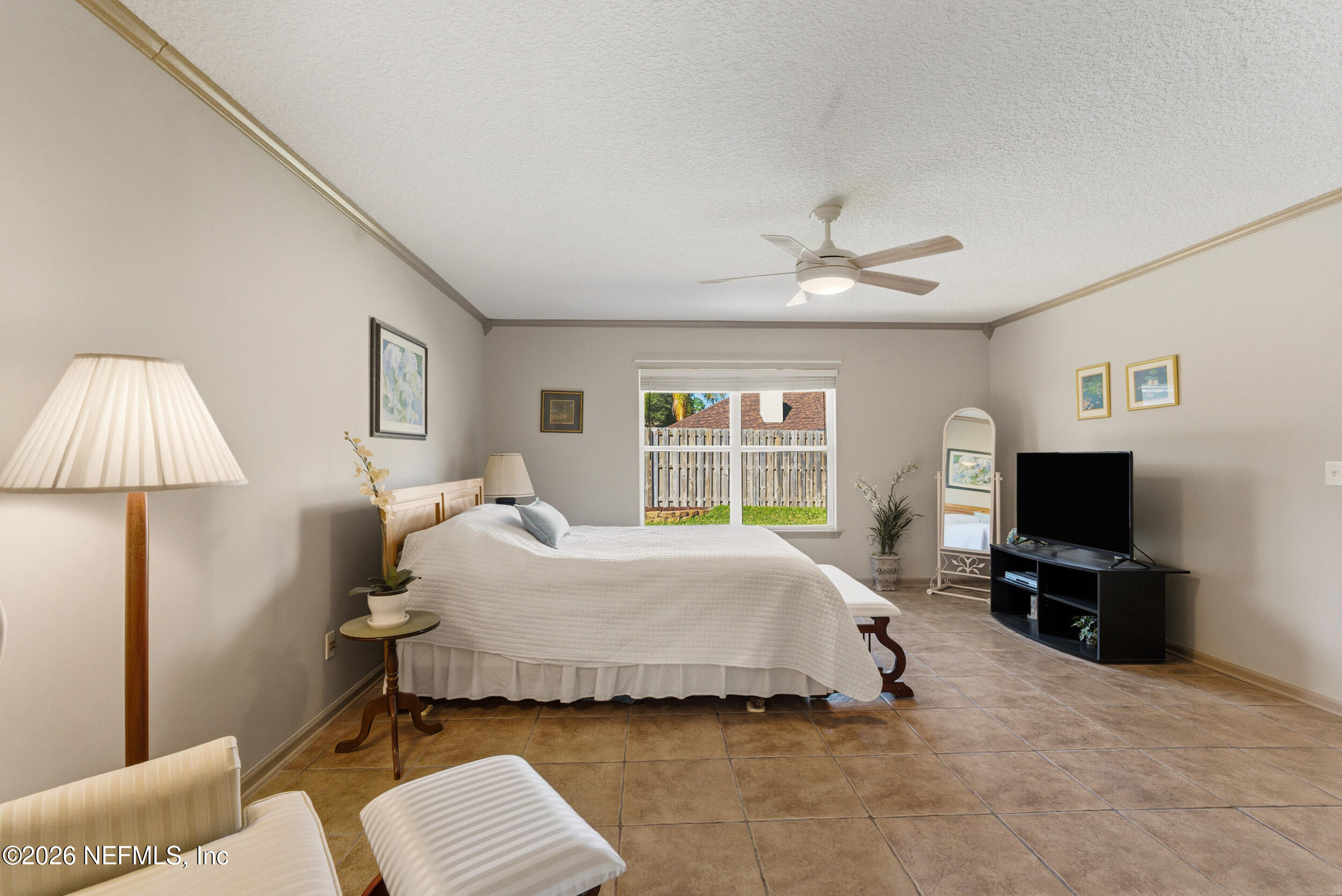 4309 Rye Court St. Johns, FL 32259 - Photo 21 of 55 a spacious bedroom with a bed and a flat screen tv