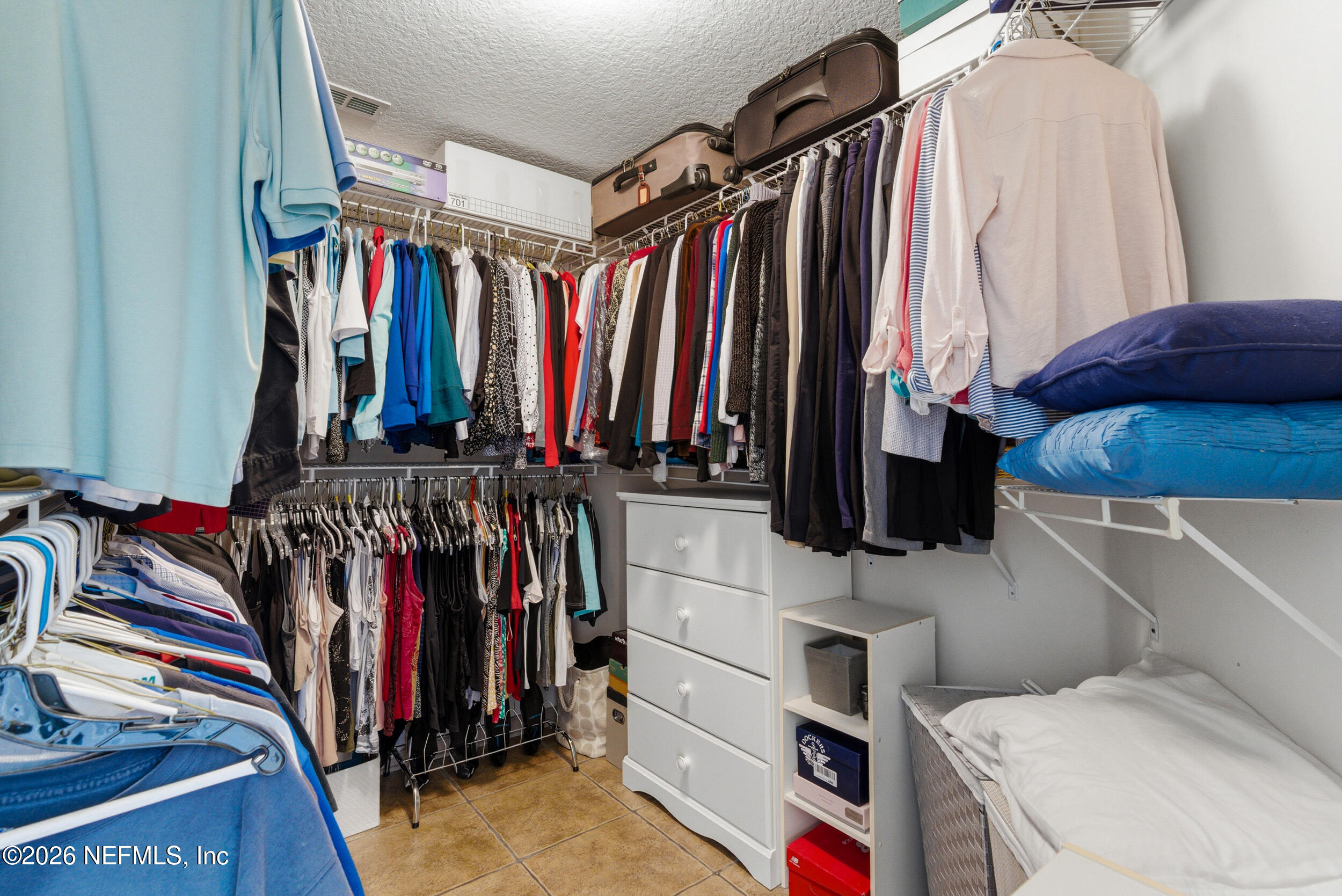 4309 Rye Court St. Johns, FL 32259 - Photo 24 of 55 a view of walk in closet with clothes and shoes