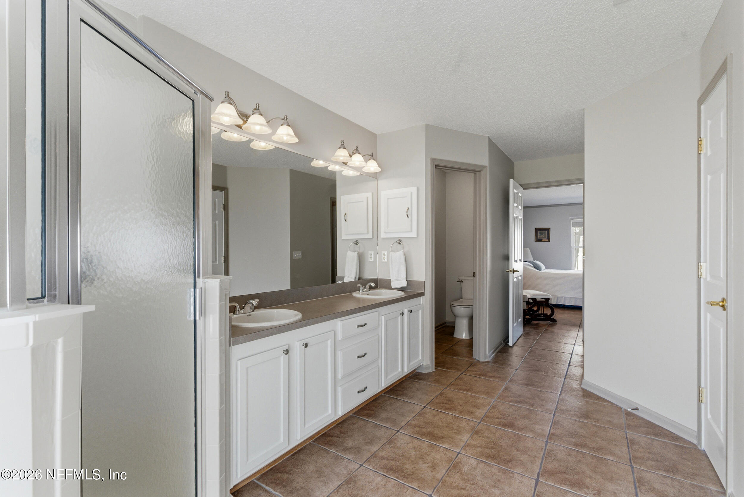 4309 Rye Court St. Johns, FL 32259 - Photo 26 of 55 a spacious bathroom with a granite countertop sink a toilet and a mirror