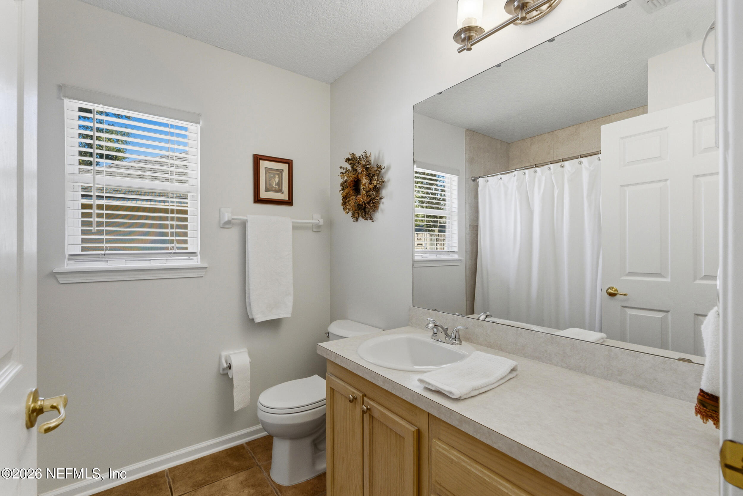 4309 Rye Court St. Johns, FL 32259 - Photo 30 of 55 a bathroom with a granite countertop sink toilet and mirror