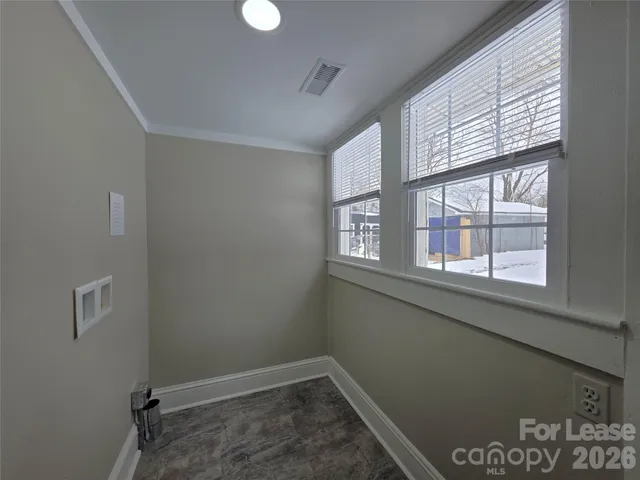 a view of a house with a parking space in front of it