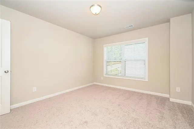 an empty room with a empty space and a window