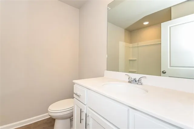 a bathroom with a sink a toilet and mirror