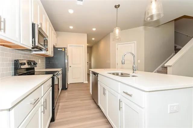 a kitchen with a sink stove and refrigerator